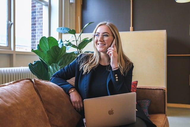 business woman talking on phone with laptop